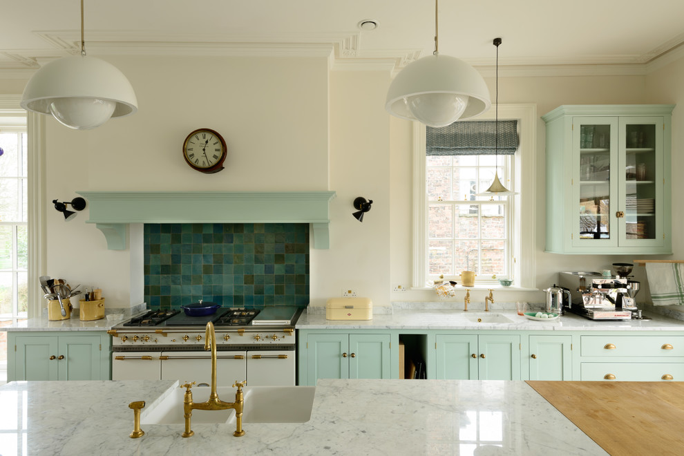 This is an example of a classic galley kitchen in Other with a belfast sink, shaker cabinets, turquoise cabinets, green splashback, white appliances, an island and grey worktops.