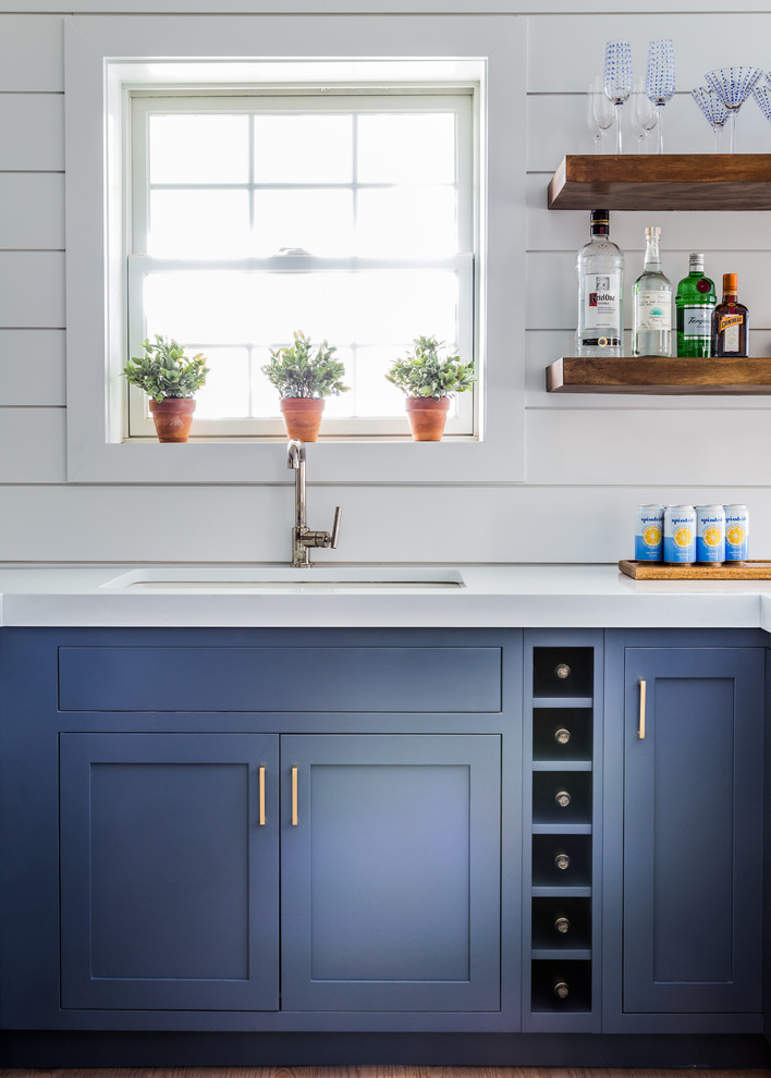 Inspiration for a coastal eat-in kitchen remodel in Other with blue cabinets and white backsplash