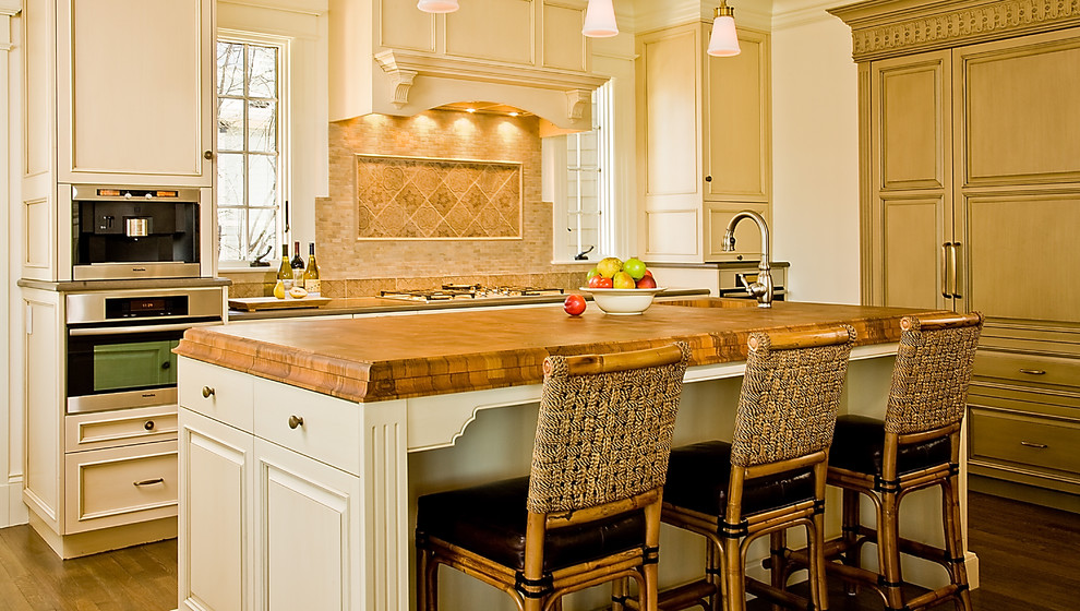 Inspiration for a timeless kitchen remodel in Boston with wood countertops and beige cabinets
