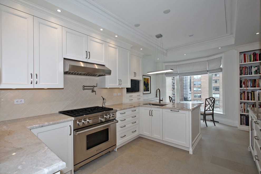 Large traditional u-shaped enclosed kitchen in Toronto with a submerged sink, recessed-panel cabinets, white cabinets, granite worktops, beige splashback, ceramic splashback, integrated appliances, limestone flooring, a breakfast bar and beige floors.