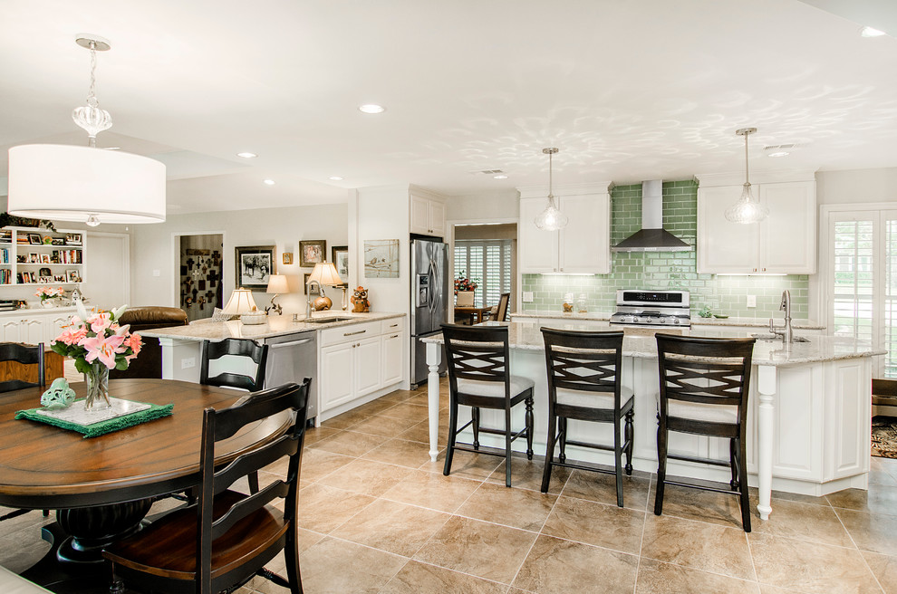 Large elegant porcelain tile eat-in kitchen photo in Dallas with a double-bowl sink, raised-panel cabinets, white cabinets, quartz countertops, green backsplash, ceramic backsplash, stainless steel appliances and an island