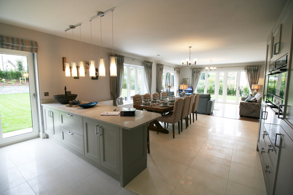 Large modern u-shaped kitchen/diner in Dublin with beaded cabinets, white cabinets, granite worktops, porcelain flooring and no island.