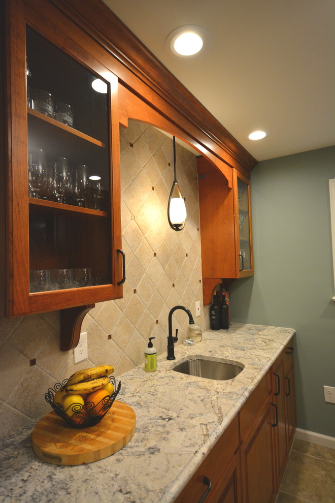 Example of a large classic galley kitchen design in Philadelphia with raised-panel cabinets, medium tone wood cabinets, quartz countertops and no island