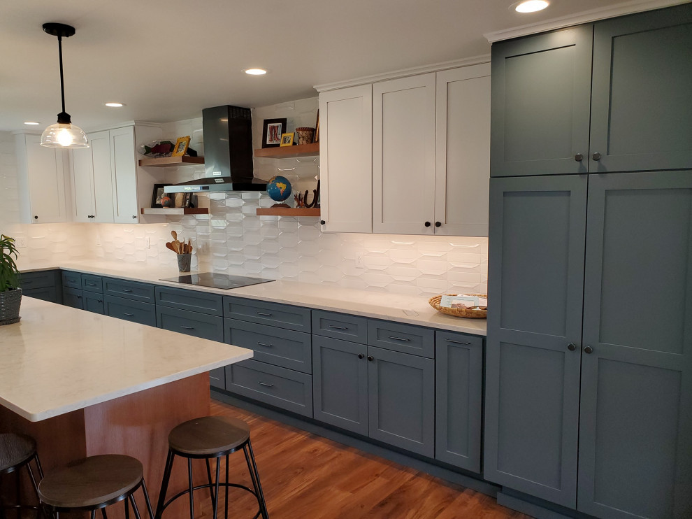 Inspiration for a huge cottage u-shaped medium tone wood floor and brown floor eat-in kitchen remodel in Other with a farmhouse sink, flat-panel cabinets, blue cabinets, quartz countertops, white backsplash, ceramic backsplash, black appliances, an island and white countertops