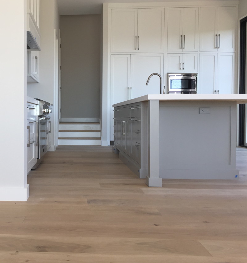Inspiration for a medium sized classic single-wall kitchen in San Francisco with shaker cabinets, white cabinets, medium hardwood flooring and an island.