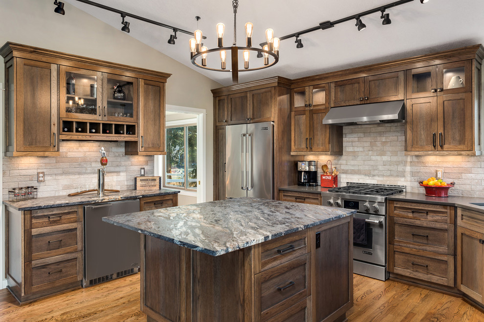 Example of a mountain style kitchen design in Portland with recessed-panel cabinets, dark wood cabinets, quartz countertops and an island
