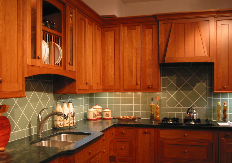 Tile back splash compliments a custom cherry kitchen by Country Side Traditional