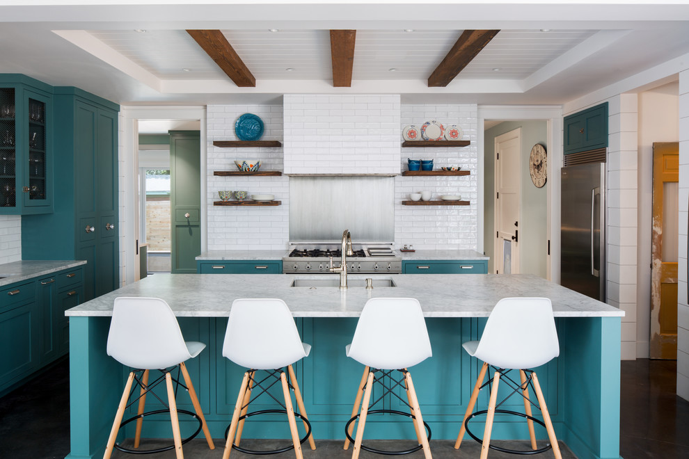 Photo of a country kitchen in Austin with a submerged sink, shaker cabinets, blue cabinets, white splashback, metro tiled splashback, stainless steel appliances, dark hardwood flooring, an island, brown floors and white worktops.