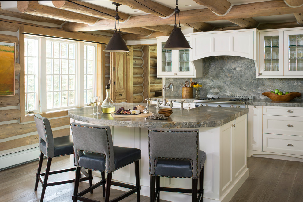 Inspiration for a mid-sized rustic l-shaped light wood floor eat-in kitchen remodel in Denver with a farmhouse sink, glass-front cabinets, white cabinets, granite countertops, gray backsplash, stone tile backsplash, stainless steel appliances and an island