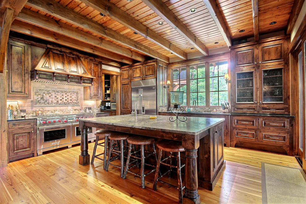Kitchen - rustic medium tone wood floor kitchen idea in Other with raised-panel cabinets, dark wood cabinets, multicolored backsplash, stainless steel appliances, an island and multicolored countertops