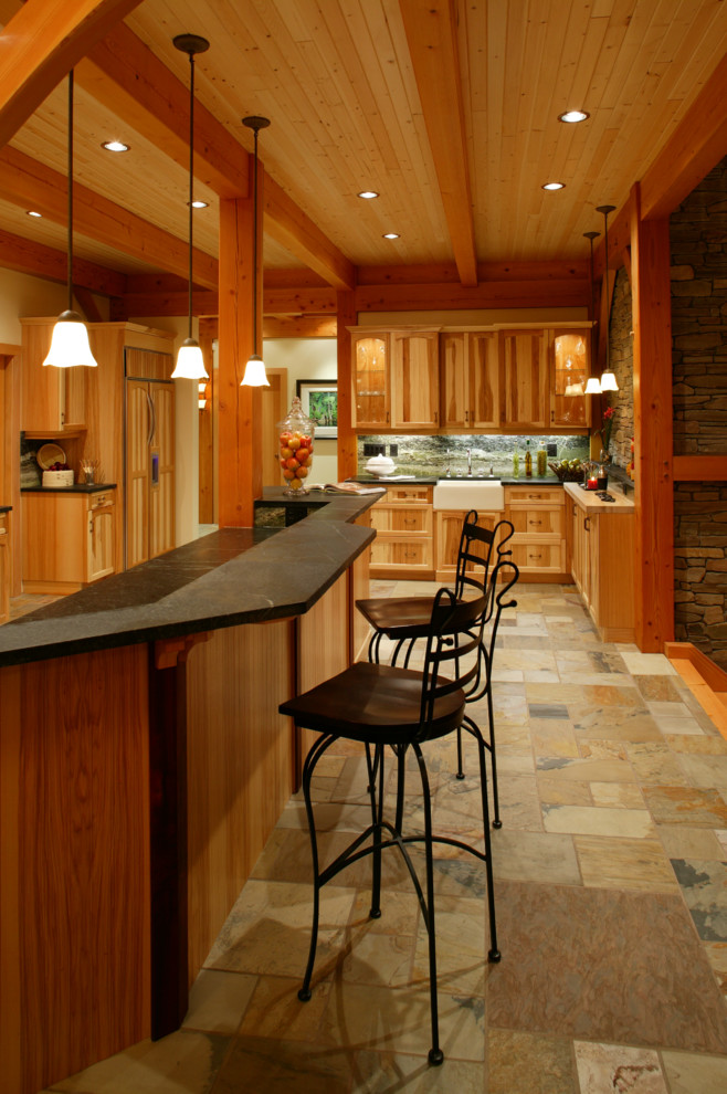 Large mountain style u-shaped travertine floor eat-in kitchen photo in Vancouver with a farmhouse sink, recessed-panel cabinets, light wood cabinets, concrete countertops, multicolored backsplash, stone slab backsplash, colored appliances and no island