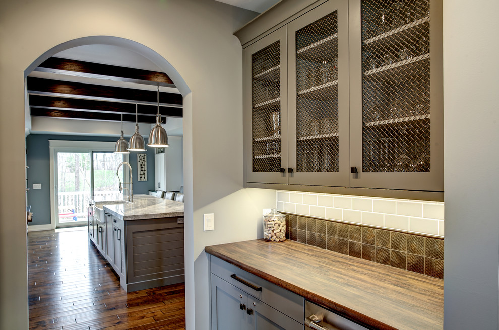 Example of an arts and crafts kitchen pantry design in Grand Rapids