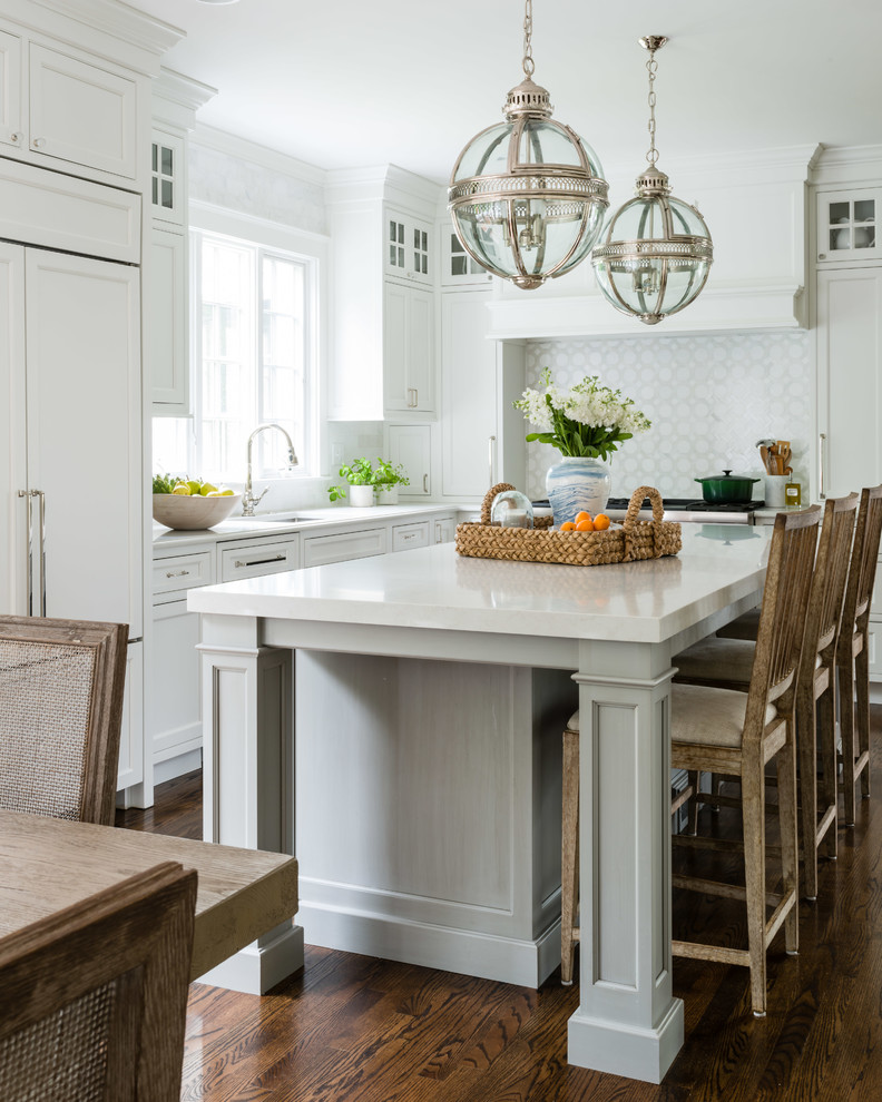 Inspiration for a coastal kitchen in Providence with a submerged sink, flat-panel cabinets, white cabinets, grey splashback, dark hardwood flooring, an island, brown floors and white worktops.