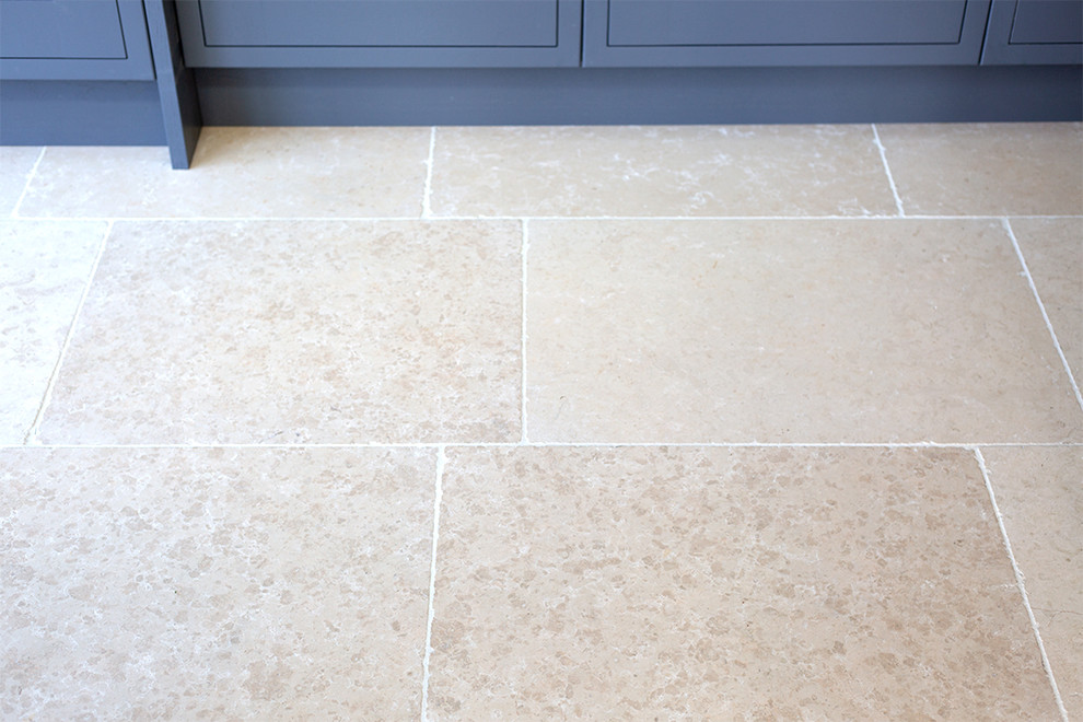 Trendy limestone floor kitchen photo in Other with an island