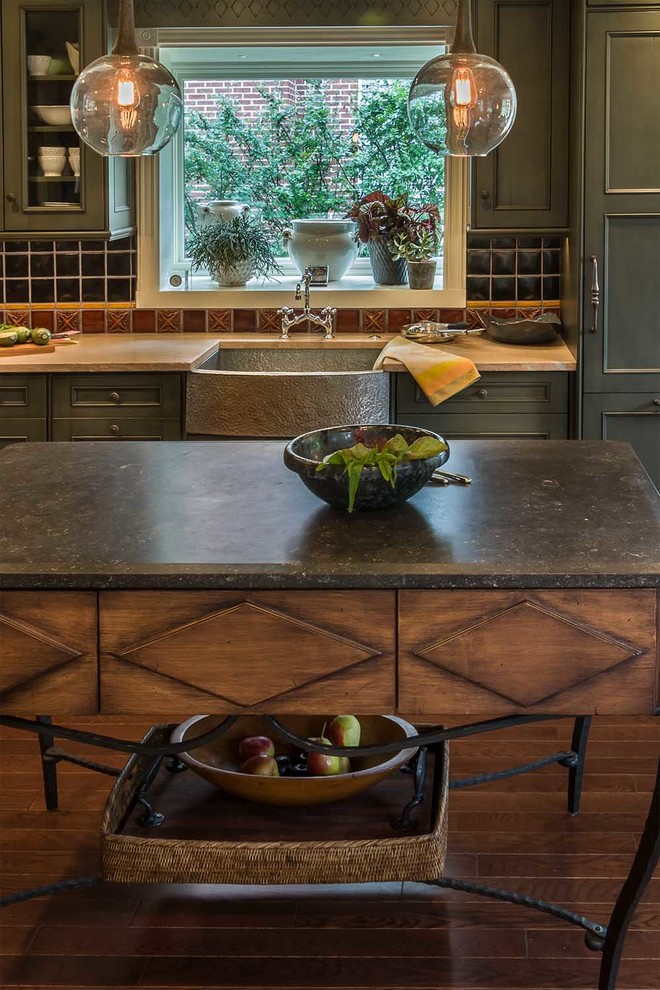 Eat-in kitchen - small cottage l-shaped medium tone wood floor and brown floor eat-in kitchen idea in Chicago with a farmhouse sink, flat-panel cabinets, green cabinets, limestone countertops, multicolored backsplash, porcelain backsplash, stainless steel appliances and an island