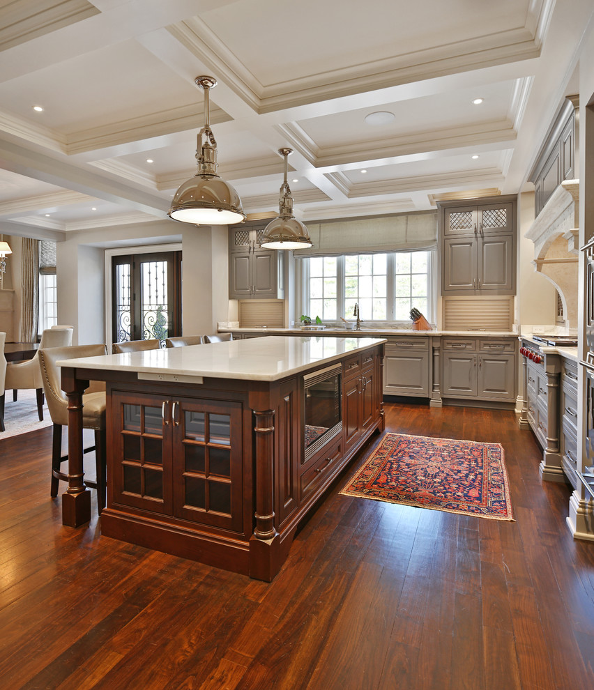 Large elegant u-shaped dark wood floor and brown floor eat-in kitchen photo in Columbus with an undermount sink, beaded inset cabinets, gray cabinets, marble countertops, white backsplash, marble backsplash, paneled appliances, an island and white countertops