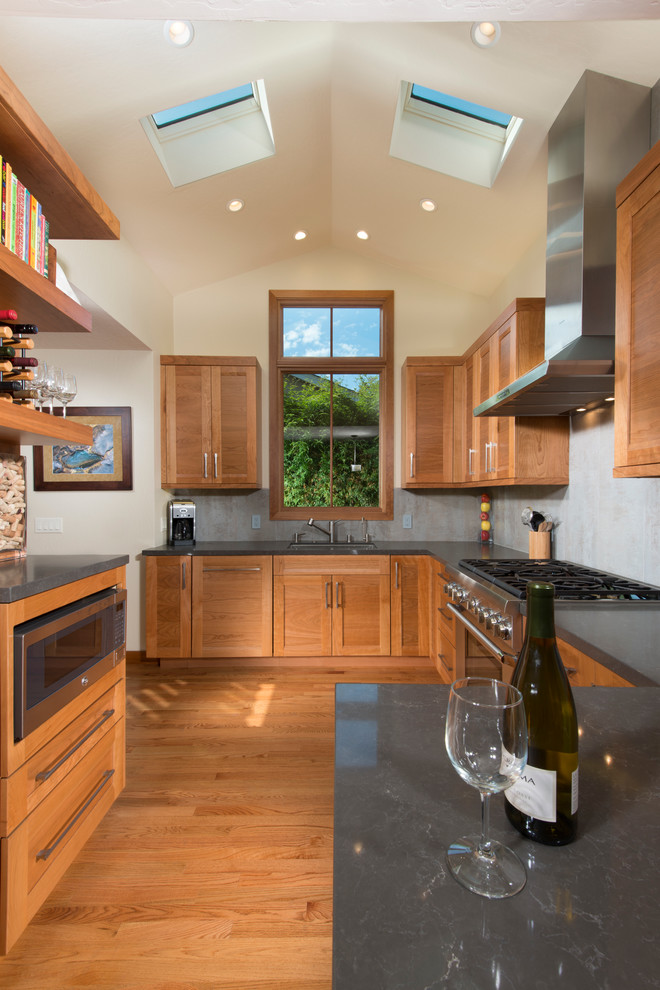 Eat-in kitchen - small transitional l-shaped light wood floor eat-in kitchen idea in San Francisco with a single-bowl sink, shaker cabinets, medium tone wood cabinets, gray backsplash, stainless steel appliances, no island, quartz countertops and porcelain backsplash