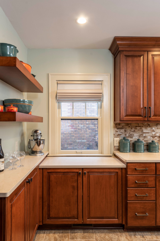 Example of a small classic galley ceramic tile and brown floor enclosed kitchen design in Indianapolis with an undermount sink, raised-panel cabinets, medium tone wood cabinets, quartz countertops, multicolored backsplash, glass tile backsplash, colored appliances, no island and white countertops