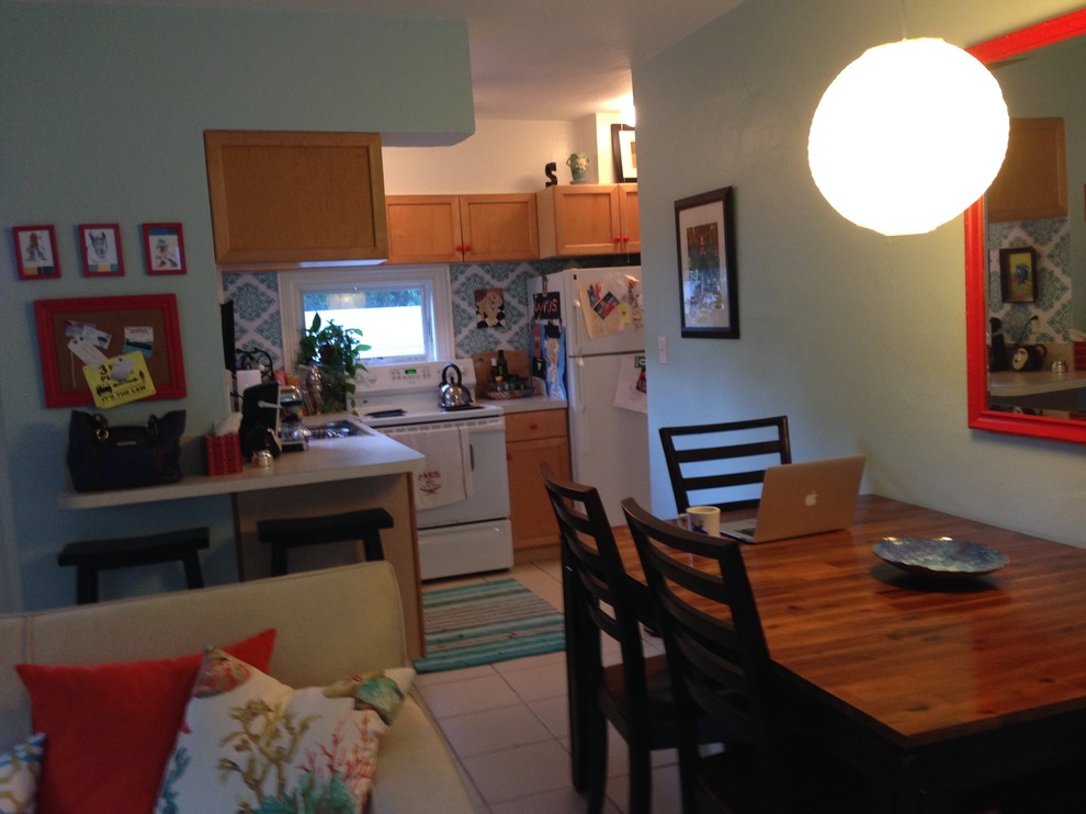 Example of a beach style l-shaped eat-in kitchen design in Miami with laminate countertops and white appliances