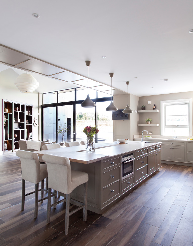 Inspiration for an expansive classic open plan kitchen in Dublin with beaded cabinets, stainless steel appliances and an island.