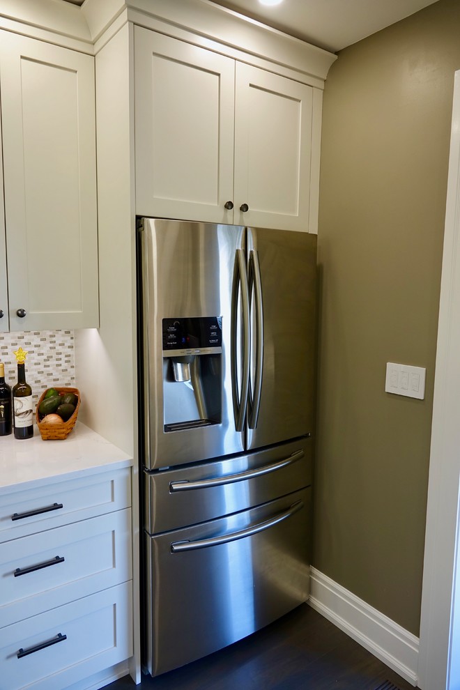Mid-sized 1960s galley kitchen pantry photo in Seattle with an undermount sink, shaker cabinets, white cabinets, quartz countertops, glass tile backsplash, stainless steel appliances and white countertops
