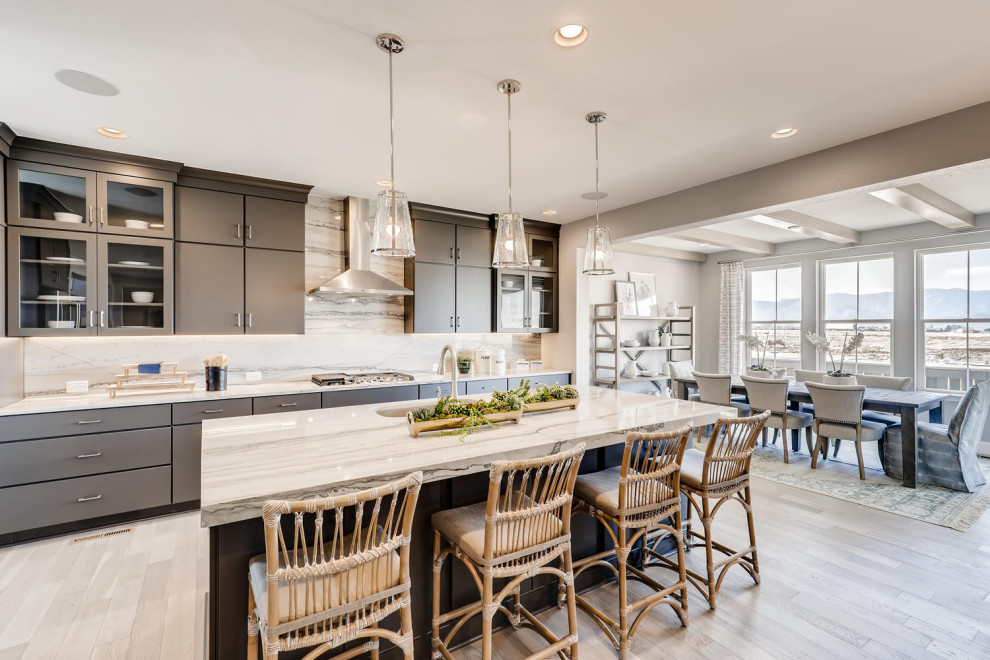Example of a minimalist single-wall light wood floor eat-in kitchen design in Denver with a drop-in sink, flat-panel cabinets, white cabinets, quartzite countertops, white backsplash, marble backsplash, stainless steel appliances, an island and white countertops