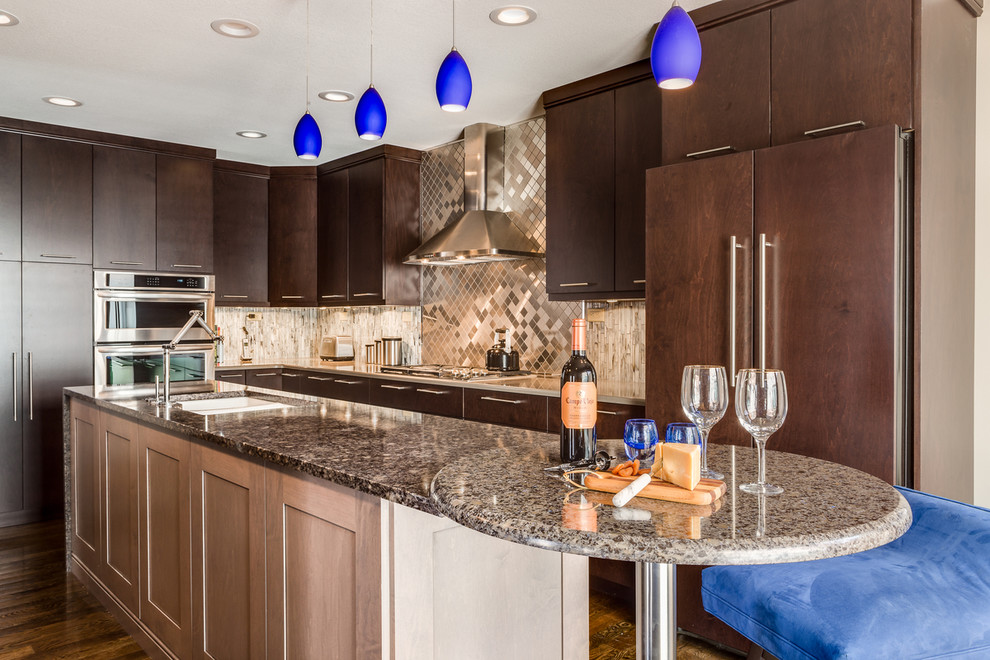This is an example of a medium sized traditional l-shaped kitchen in Kansas City with a double-bowl sink, flat-panel cabinets, dark wood cabinets, metallic splashback, metal splashback, dark hardwood flooring and an island.