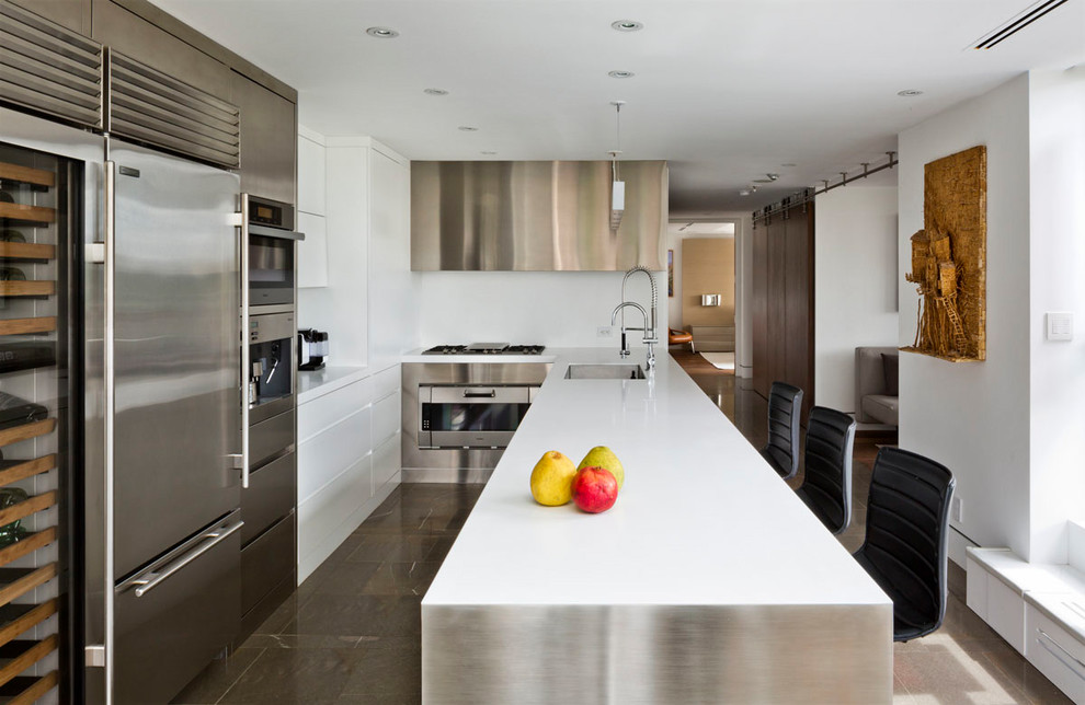 Moderne Küche in U-Form mit Waschbecken, flächenbündigen Schrankfronten, Edelstahlfronten, Küchenrückwand in Weiß, Küchengeräten aus Edelstahl und Halbinsel in Toronto