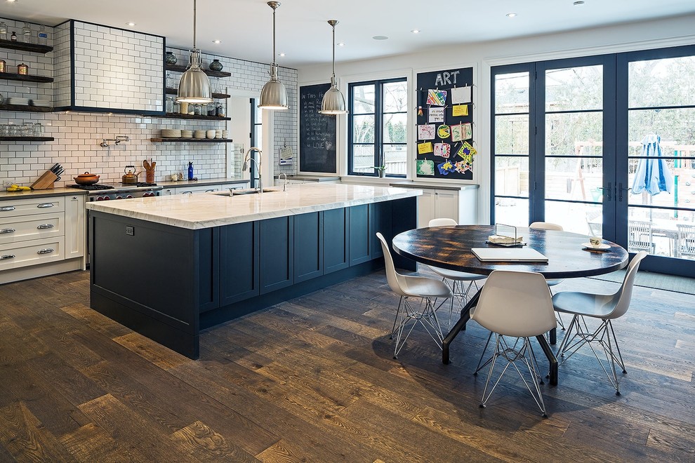 This is an example of a large traditional kitchen/diner in Toronto with white splashback, stainless steel appliances, dark hardwood flooring, an island, a double-bowl sink, recessed-panel cabinets, white cabinets, granite worktops and metro tiled splashback.