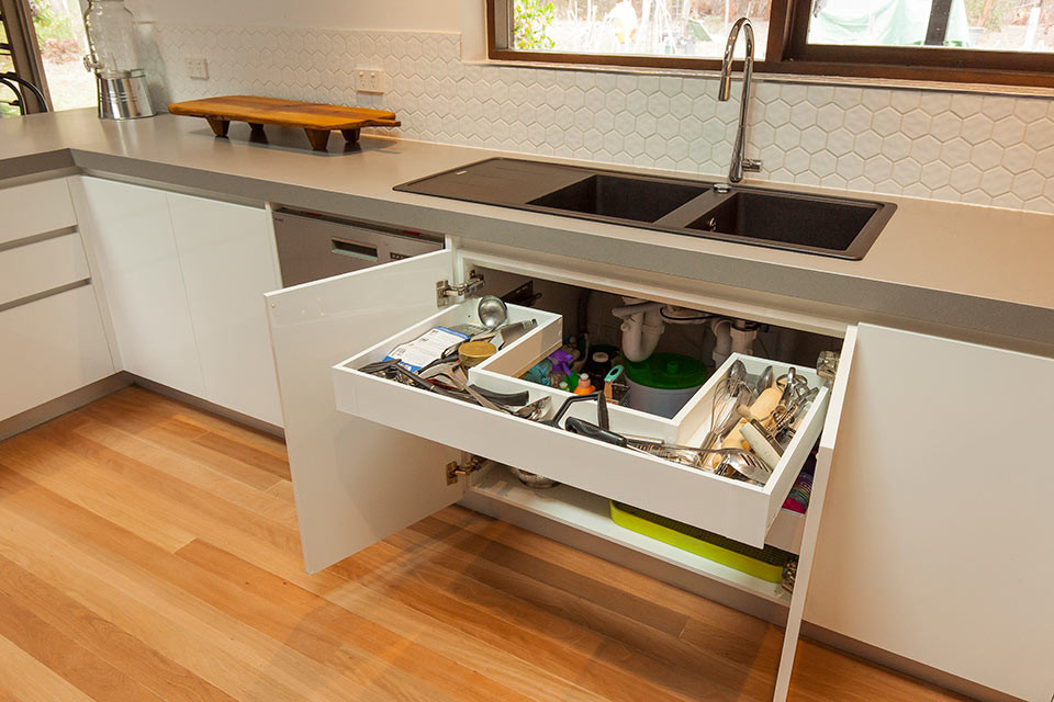 Example of a mid-sized trendy u-shaped light wood floor eat-in kitchen design in Geelong with a double-bowl sink, flat-panel cabinets, white cabinets, quartz countertops, white backsplash, ceramic backsplash, stainless steel appliances and no island