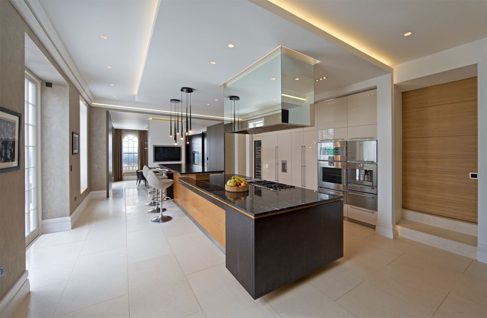 Large contemporary single-wall open plan kitchen in Hertfordshire with flat-panel cabinets, white cabinets, granite worktops and an island.