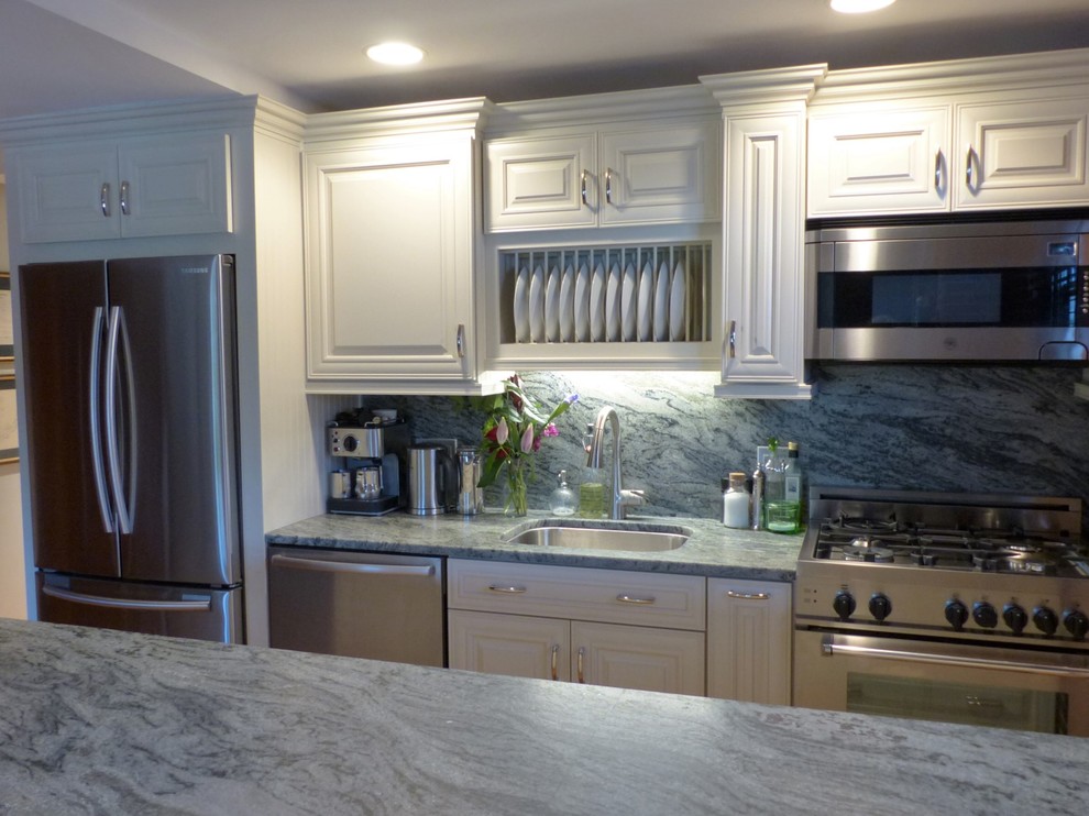 Example of a small classic galley light wood floor and yellow floor eat-in kitchen design in Boston with an undermount sink, raised-panel cabinets, white cabinets, granite countertops, pink backsplash, stone slab backsplash, stainless steel appliances and an island