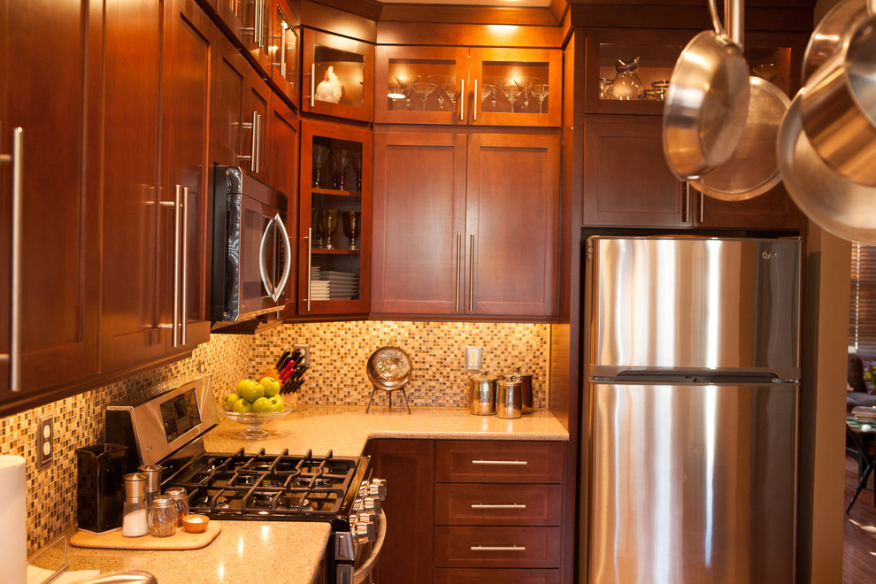 Small transitional u-shaped eat-in kitchen photo in New York with an undermount sink, shaker cabinets, brown cabinets, quartz countertops, multicolored backsplash, mosaic tile backsplash and white appliances