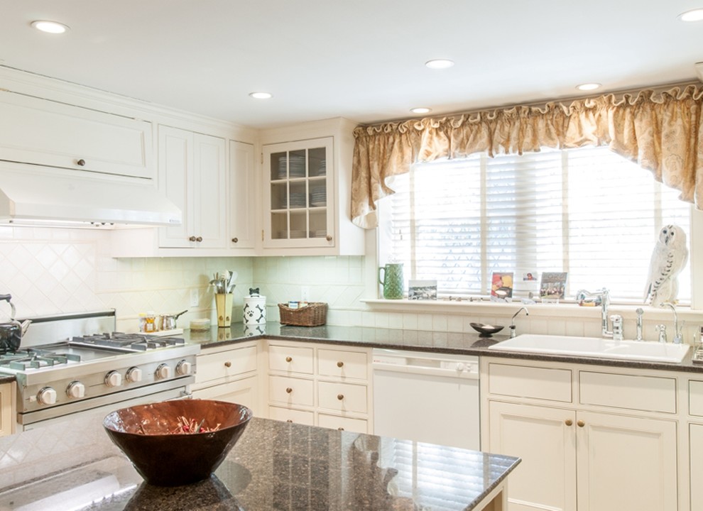 Example of a classic u-shaped eat-in kitchen design in Boston with a double-bowl sink, granite countertops, white backsplash, ceramic backsplash and an island