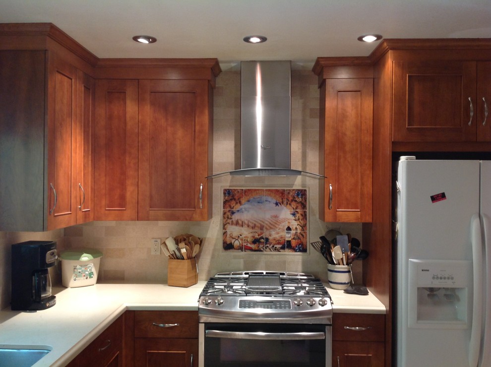 Photo of a medium sized classic l-shaped kitchen/diner in San Francisco with a single-bowl sink, recessed-panel cabinets, medium wood cabinets, beige splashback, stainless steel appliances and no island.