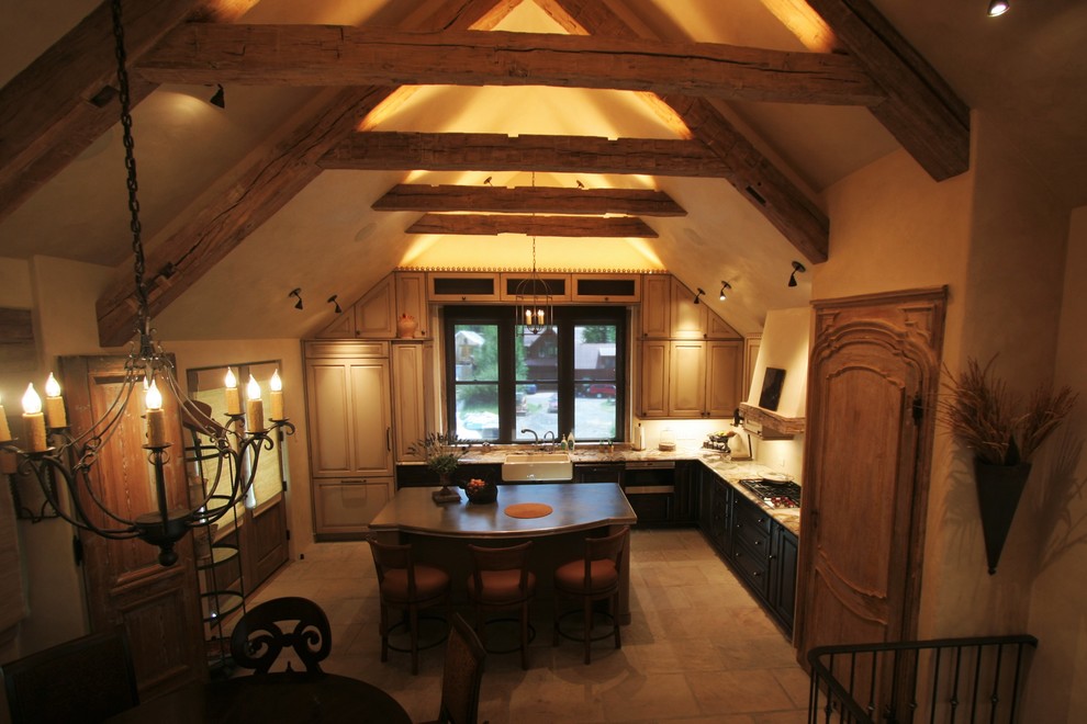 Example of a mid-sized classic l-shaped ceramic tile open concept kitchen design in Denver with a farmhouse sink, raised-panel cabinets, paneled appliances, an island, black cabinets and soapstone countertops