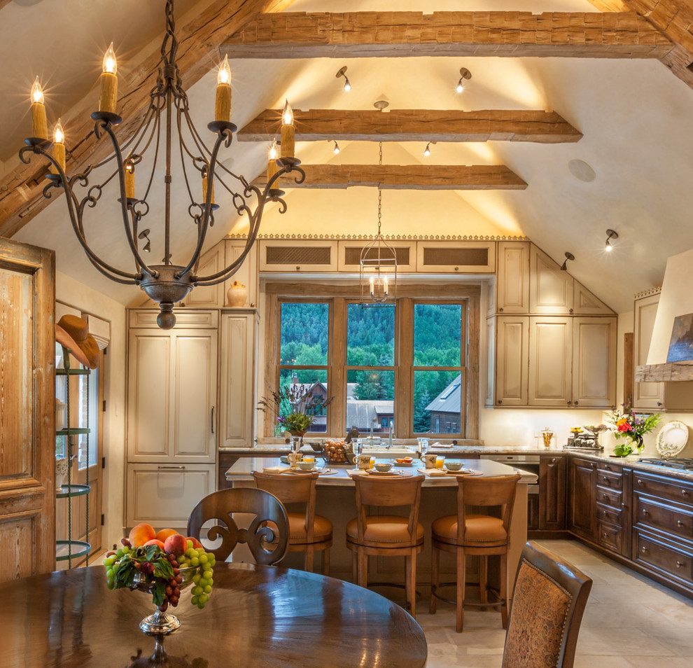 Elegant l-shaped ceramic tile open concept kitchen photo in Denver with a farmhouse sink, raised-panel cabinets, paneled appliances, an island, dark wood cabinets and granite countertops