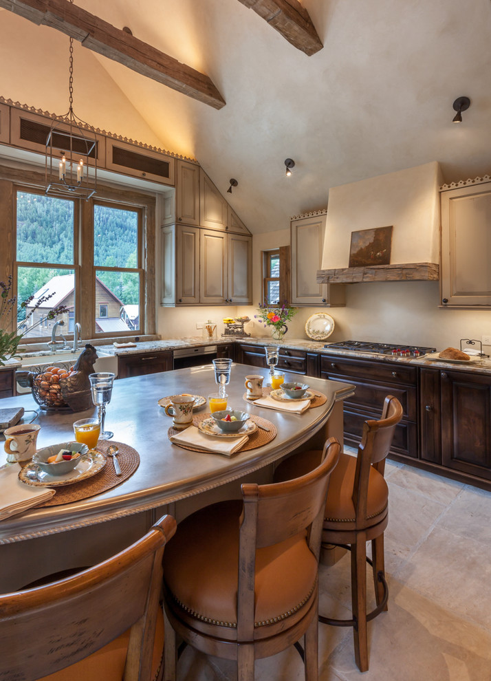 Example of a mid-sized classic l-shaped ceramic tile open concept kitchen design in Denver with a farmhouse sink, raised-panel cabinets, paneled appliances, an island, dark wood cabinets and granite countertops
