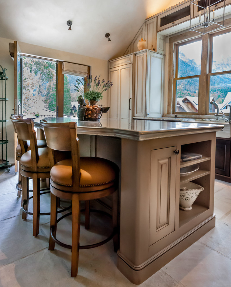 Example of a mid-sized classic l-shaped ceramic tile open concept kitchen design in Denver with a farmhouse sink, raised-panel cabinets, paneled appliances, an island, dark wood cabinets and granite countertops