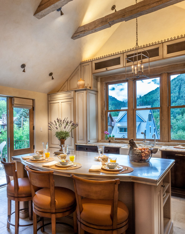 Example of a mid-sized classic l-shaped ceramic tile open concept kitchen design in Denver with raised-panel cabinets, paneled appliances, an island, a farmhouse sink, dark wood cabinets and granite countertops