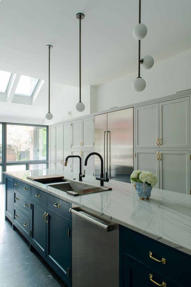 Inspiration for a traditional galley kitchen in Chicago with a submerged sink, shaker cabinets, grey cabinets, an island, grey floors and white worktops.