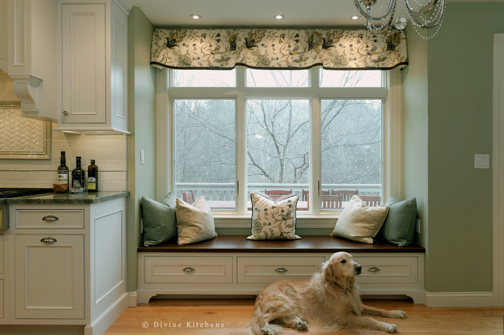 Example of a large classic l-shaped medium tone wood floor eat-in kitchen design in Boston with an undermount sink, beaded inset cabinets, white cabinets, granite countertops, white backsplash, ceramic backsplash, stainless steel appliances and an island