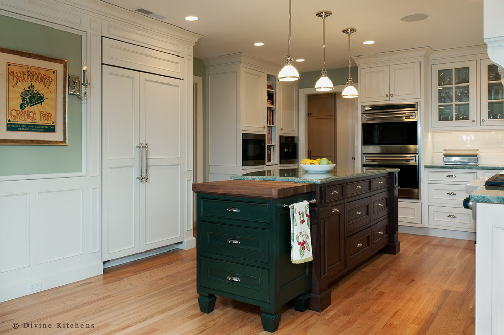 Eat-in kitchen - large traditional l-shaped medium tone wood floor eat-in kitchen idea in Boston with an undermount sink, beaded inset cabinets, white cabinets, granite countertops, white backsplash, ceramic backsplash, stainless steel appliances and an island