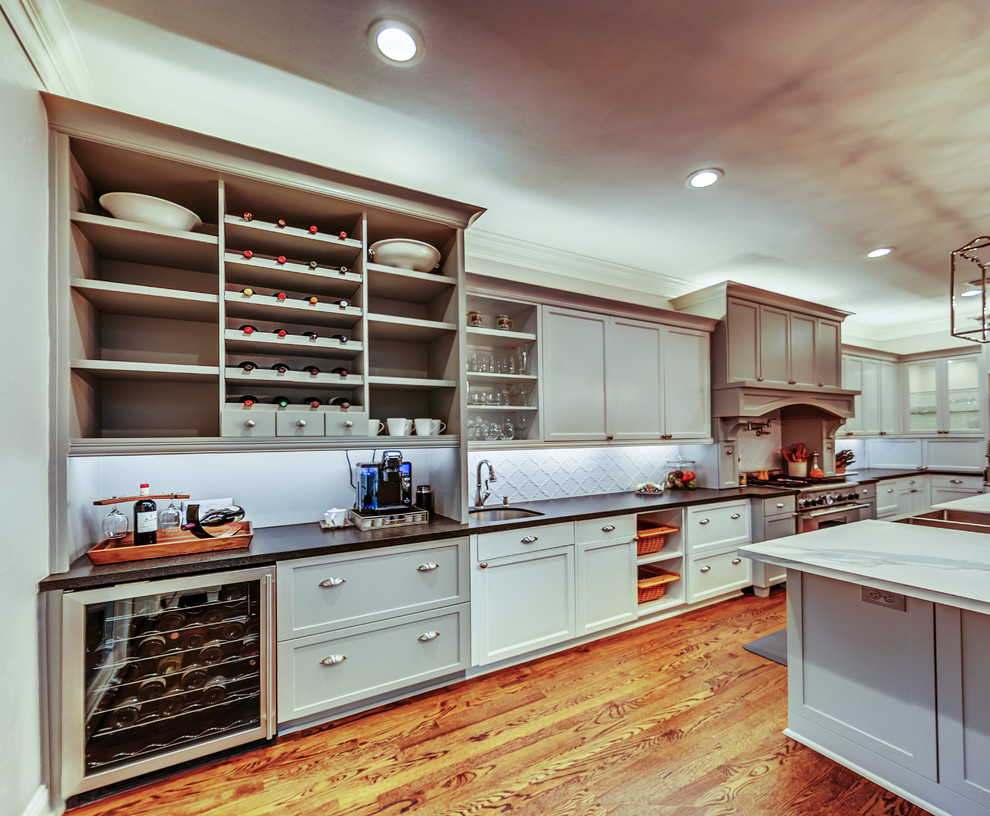 Exempel på ett stort klassiskt kök, med en rustik diskho, skåp i shakerstil, vita skåp, bänkskiva i kvartsit, vitt stänkskydd, stänkskydd i glaskakel, mellanmörkt trägolv, en köksö och brunt golv