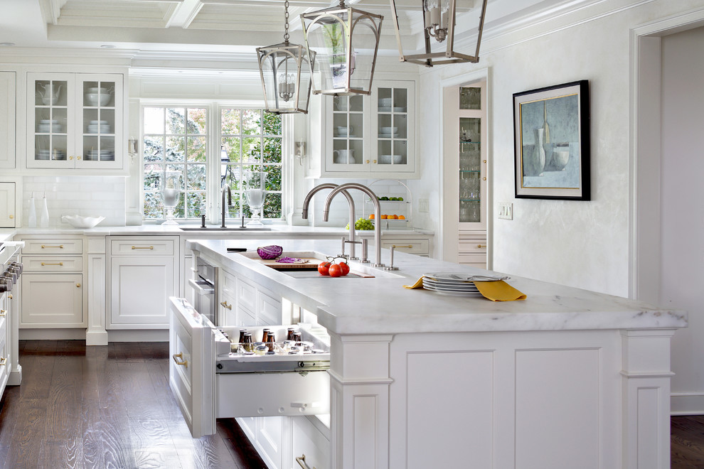 Eat-in kitchen - large traditional l-shaped medium tone wood floor eat-in kitchen idea in New York with an undermount sink, beaded inset cabinets, white cabinets, marble countertops, white backsplash, stone tile backsplash, paneled appliances and an island