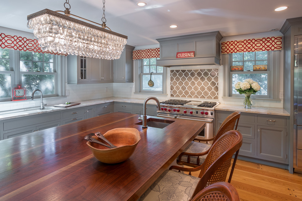 Eat-in kitchen - large traditional light wood floor eat-in kitchen idea in New York with beaded inset cabinets, brown backsplash, stainless steel appliances and an island