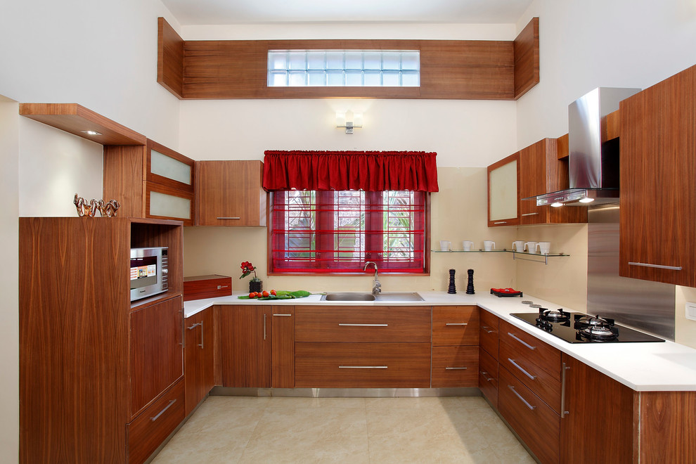 U-shaped beige floor kitchen photo in Other with a drop-in sink, flat-panel cabinets, medium tone wood cabinets, beige backsplash, no island and white countertops