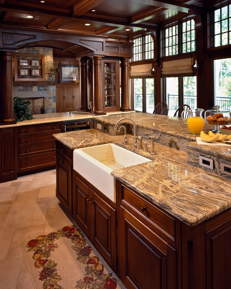 Open concept kitchen - large traditional l-shaped travertine floor open concept kitchen idea in New York with a farmhouse sink, raised-panel cabinets, dark wood cabinets and an island
