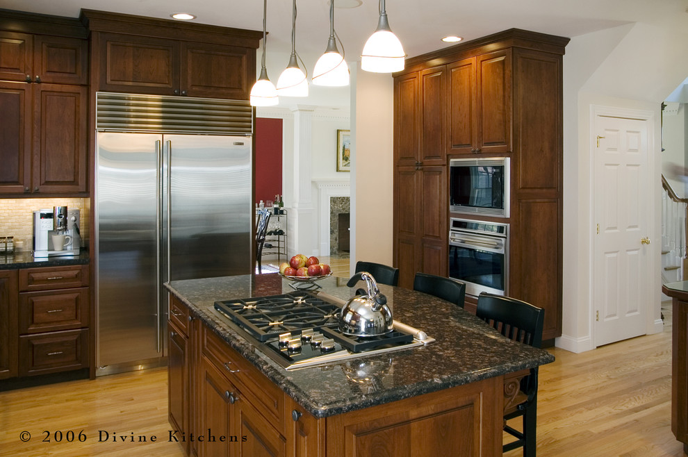 Mid-sized elegant l-shaped light wood floor eat-in kitchen photo in Boston with a double-bowl sink, beaded inset cabinets, dark wood cabinets, granite countertops, beige backsplash, stone tile backsplash, stainless steel appliances and an island