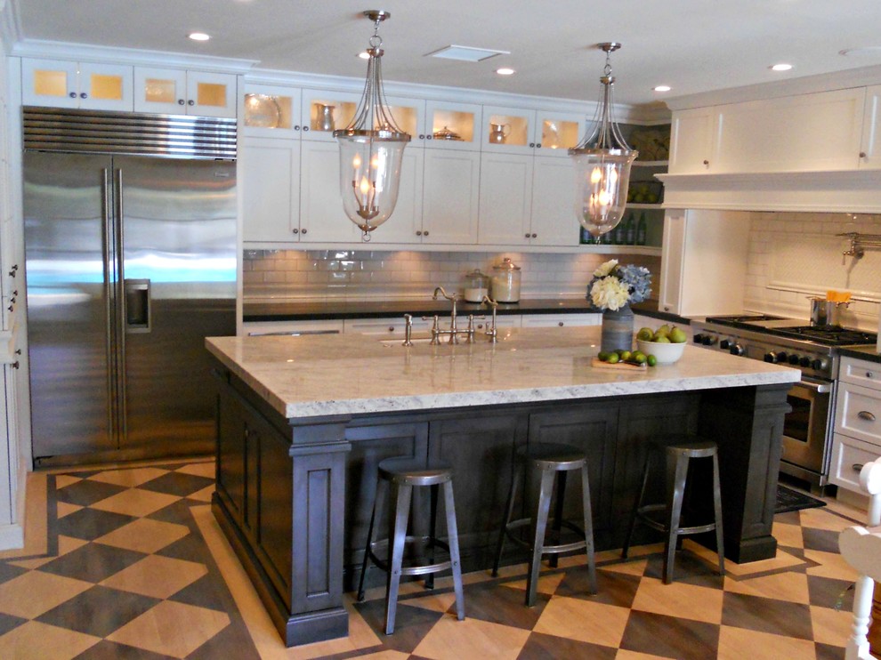 Example of a large classic u-shaped painted wood floor eat-in kitchen design in Phoenix with a farmhouse sink, shaker cabinets, white cabinets, granite countertops, white backsplash, subway tile backsplash and stainless steel appliances